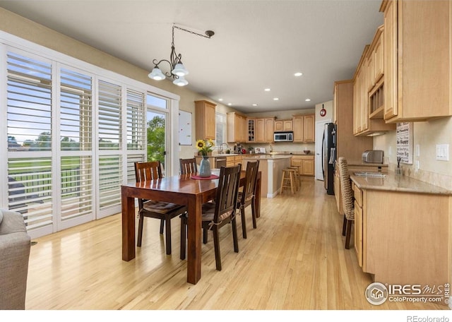14246 Piney River Rd, Broomfield, CO 80023 - dining room with light wood-style floors, a chandelier, and recessed lighting