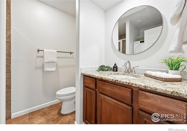 4039 N Clay St, Denver, CO 80211 - bathroom with vanity, washer / clothes dryer, toilet, baseboards, and tile patterned floors