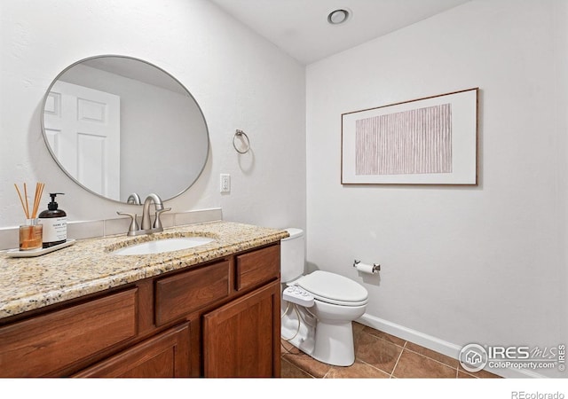 4039 N Clay St, Denver, CO 80211 - bathroom featuring vanity, toilet, tile patterned floors, and baseboards