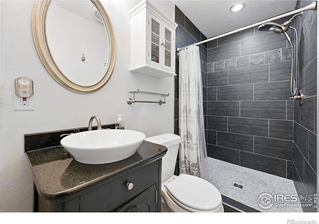 4039 N Clay St, Denver, CO 80211 - full bathroom with a tile shower, toilet, and vanity
