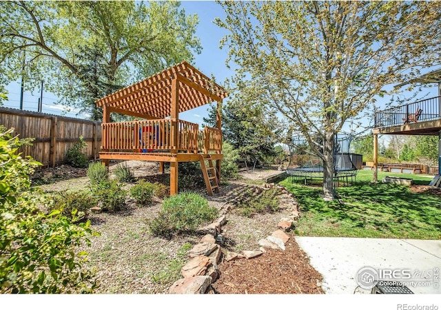 1067 W Alder St, Louisville, CO 80027 - fenced backyard with a trampoline and a deck