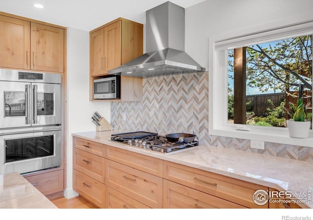 1067 W Alder St, Louisville, CO 80027 - kitchen with wall chimney range hood, appliances with stainless steel finishes, light brown cabinets, light stone countertops, and recessed lighting