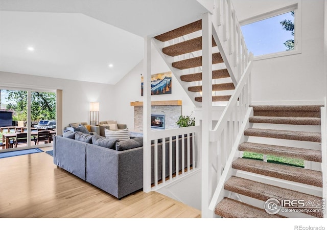 1067 W Alder St, Louisville, CO 80027 - living room with wood finished floors, stairs, vaulted ceiling, a fireplace, and recessed lighting