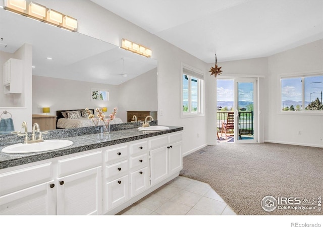 1067 W Alder St, Louisville, CO 80027 - bathroom featuring double vanity, vaulted ceiling, and tile patterned flooring