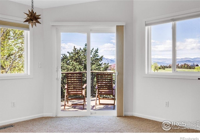 1067 W Alder St, Louisville, CO 80027 - entryway with carpet flooring, a mountain view, and plenty of natural light