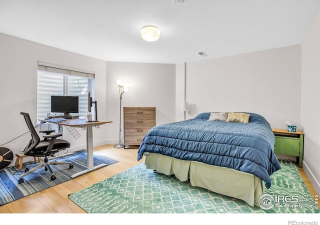 1067 W Alder St, Louisville, CO 80027 - bedroom with wood finished floors and an office area