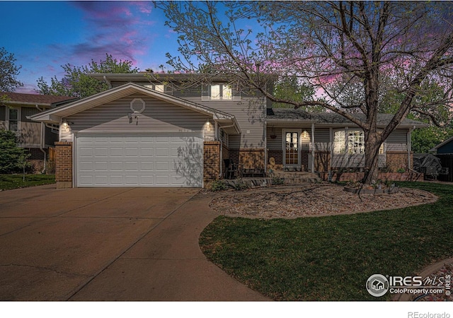 514 Palisade Mountain Dr, Windsor, CO 80550 - view of front facade featuring brick siding, driveway, an attached garage, and a lawn