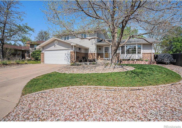514 Palisade Mountain Dr, Windsor, CO 80550 - view of front of house with brick siding, a garage, concrete driveway, and a front lawn