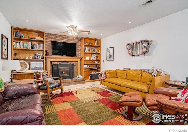 514 Palisade Mountain Dr, Windsor, CO 80550 - living room featuring ceiling fan, built in shelves, and a fireplace