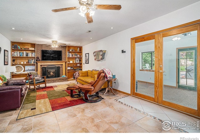 514 Palisade Mountain Dr, Windsor, CO 80550 - living room with ceiling fan, built in shelves, baseboards, a textured ceiling, and light tile patterned flooring