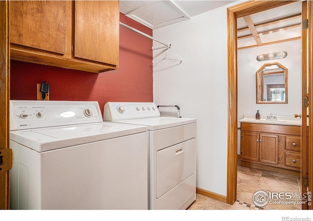 514 Palisade Mountain Dr, Windsor, CO 80550 - washroom featuring cabinet space, washing machine and clothes dryer, baseboards, and light tile patterned floors