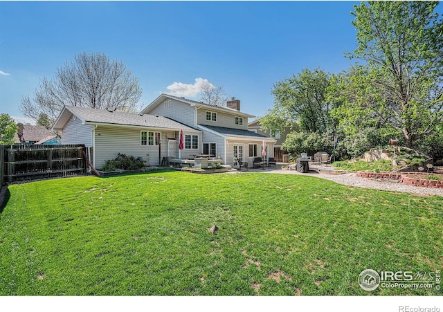 514 Palisade Mountain Dr, Windsor, CO 80550 - rear view of property with a patio and a chimney