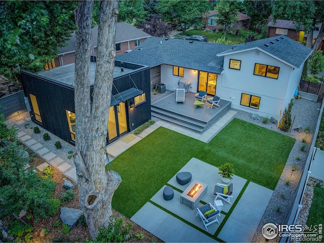 1670 Linden Ave, Boulder, CO 80304 - rear view of house featuring an outdoor fire pit, a wooden deck, roof with shingles, and a patio area