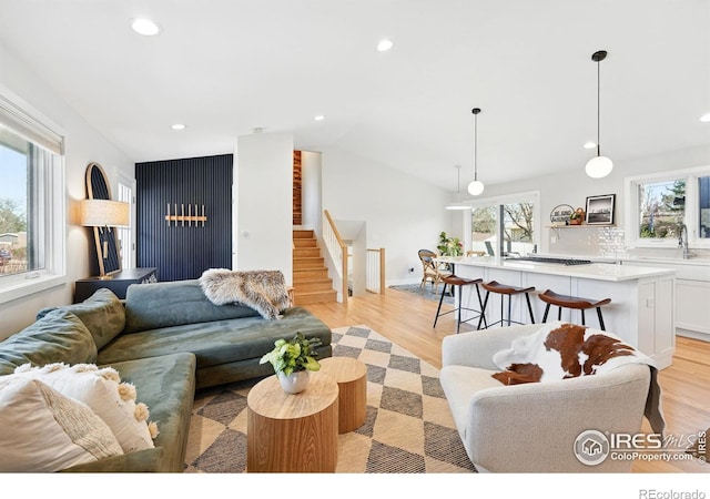 1670 Linden Ave, Boulder, CO 80304 - living room featuring stairs, vaulted ceiling, recessed lighting, and light wood finished floors