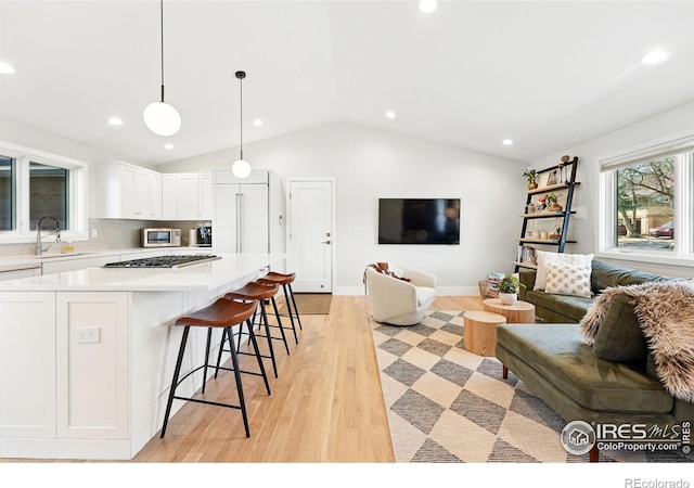 1670 Linden Ave, Boulder, CO 80304 - kitchen featuring open floor plan, appliances with stainless steel finishes, vaulted ceiling, a sink, and light countertops