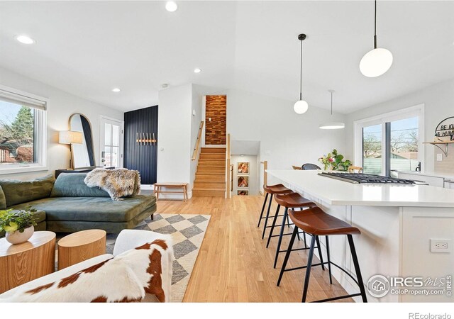 1670 Linden Ave, Boulder, CO 80304 - living room featuring stairs, healthy amount of natural light, light wood finished floors, recessed lighting, and lofted ceiling