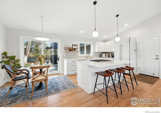 1670 Linden Ave, Boulder, CO 80304 - kitchen featuring stainless steel gas cooktop, light countertops, white cabinets, light wood-style flooring, and recessed lighting