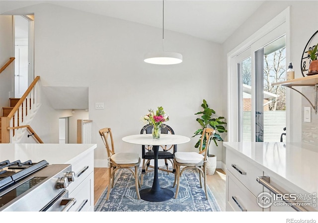 1670 Linden Ave, Boulder, CO 80304 - dining area featuring lofted ceiling, light wood finished floors, baseboards, and stairs