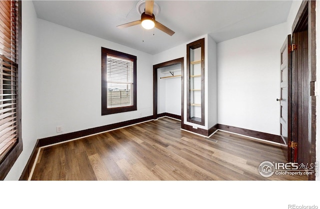 9571 Gray Ave, Carr, CO 80612 - unfurnished bedroom featuring wood finished floors, baseboards, and a ceiling fan