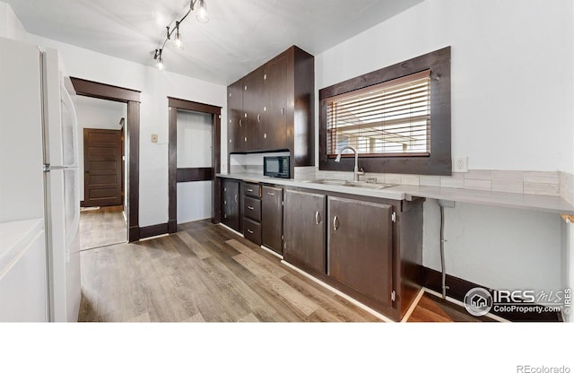9571 Gray Ave, Carr, CO 80612 - kitchen with a sink, freestanding refrigerator, dark brown cabinets, and black microwave