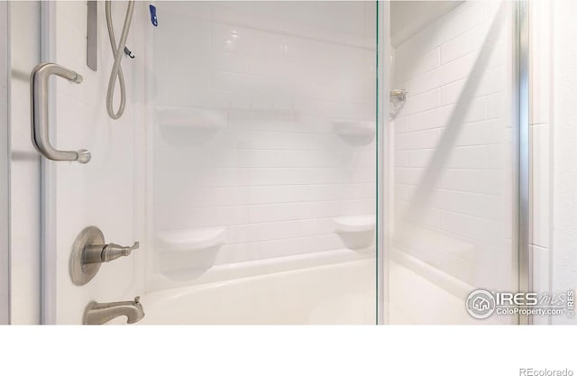 9571 Gray Ave, Carr, CO 80612 - bathroom featuring combined bath / shower with glass door
