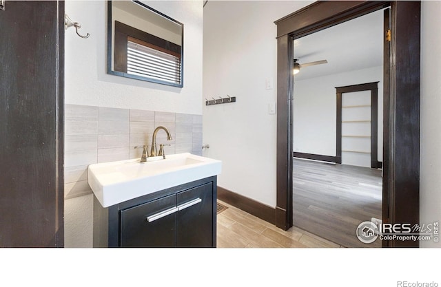 9571 Gray Ave, Carr, CO 80612 - bathroom featuring vanity, wood finished floors, and ceiling fan