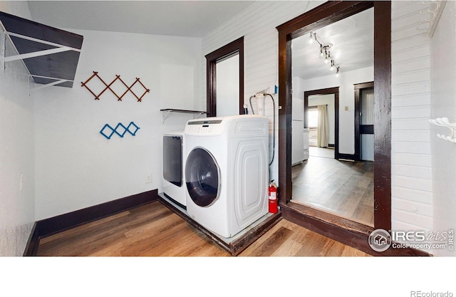 9571 Gray Ave, Carr, CO 80612 - washroom with washing machine and dryer, wood finished floors, and baseboards