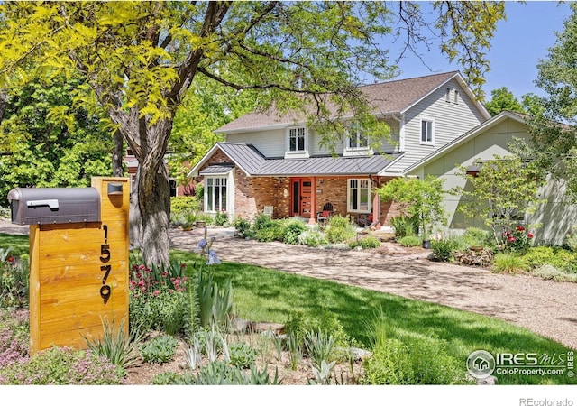 1579 W Costilla Pl, Littleton, CO 80120 - traditional-style home featuring a standing seam roof, covered porch, metal roof, and brick siding