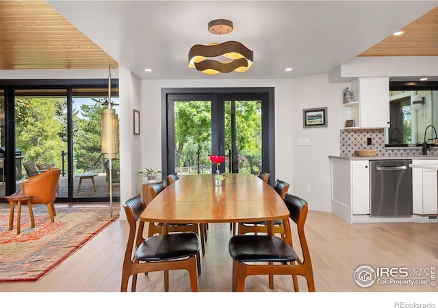 1579 W Costilla Pl, Littleton, CO 80120 - dining room featuring healthy amount of natural light, light wood finished floors, recessed lighting, french doors, and baseboards