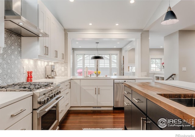 1816 Mariposa Ave, Boulder, CO 80302 - kitchen with wall chimney exhaust hood, appliances with stainless steel finishes, butcher block counters, dark wood finished floors, and white cabinetry