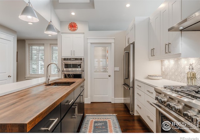 1816 Mariposa Ave, Boulder, CO 80302 - kitchen featuring wooden counters, wall chimney range hood, stainless steel appliances, a sink, and white cabinets