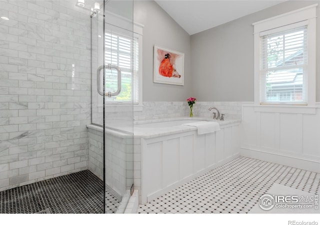 1816 Mariposa Ave, Boulder, CO 80302 - bathroom featuring a shower stall, a bath, plenty of natural light, wainscoting, and lofted ceiling