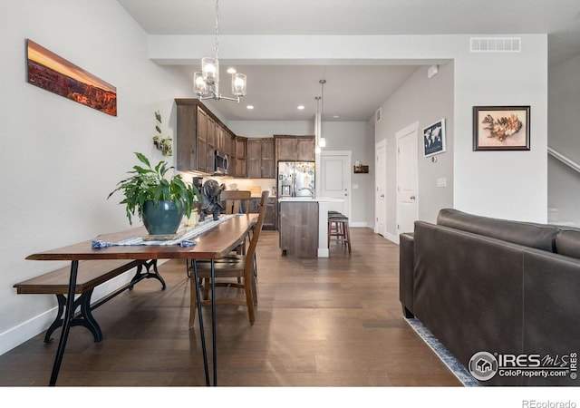 5111 Longshaw Ct Unit 5, Windsor, CO 80528 - dining space featuring dark wood finished floors, a chandelier, recessed lighting, and baseboards
