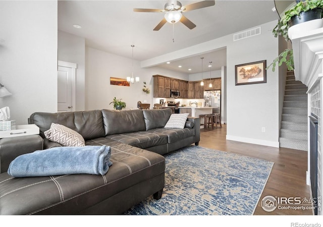 5111 Longshaw Ct Unit 5, Windsor, CO 80528 - living room with ceiling fan, dark wood-style floors, recessed lighting, baseboards, and a chandelier