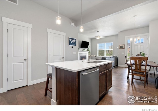 5111 Longshaw Ct Unit 5, Windsor, CO 80528 - kitchen with dishwasher, a sink, dark wood-style flooring, and a fireplace