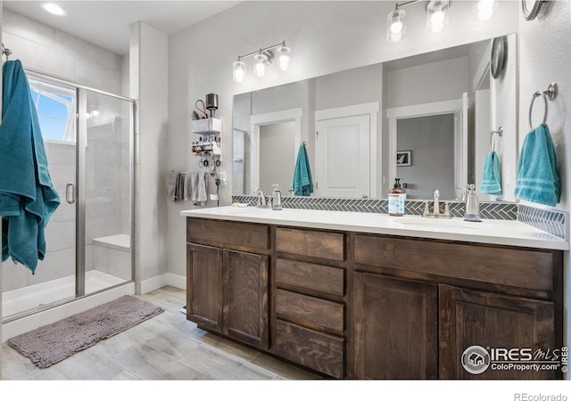 5111 Longshaw Ct Unit 5, Windsor, CO 80528 - bathroom featuring double vanity, a stall shower, and decorative backsplash