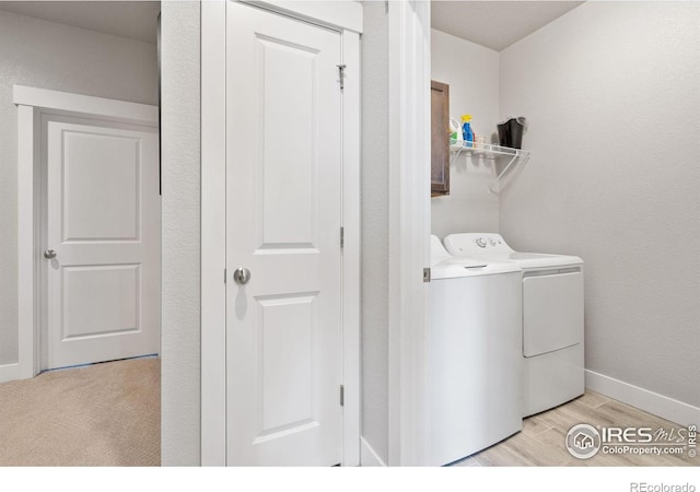 5111 Longshaw Ct Unit 5, Windsor, CO 80528 - laundry area with washer and dryer, cabinet space, light wood-style floors, and baseboards