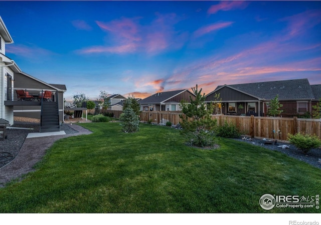 7061 Sage Meadows Dr, Wellington, CO 80549 - yard at dusk with a residential view, stairway, and a deck