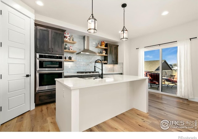 7061 Sage Meadows Dr, Wellington, CO 80549 - kitchen featuring wall chimney exhaust hood, open shelves, a sink, light countertops, and light wood-style floors