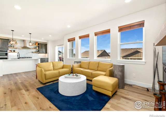 7061 Sage Meadows Dr, Wellington, CO 80549 - living room featuring recessed lighting, light wood finished floors, and baseboards