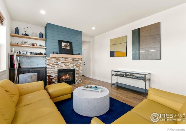 7061 Sage Meadows Dr, Wellington, CO 80549 - living room featuring wood finished floors, a stone fireplace, recessed lighting, and baseboards