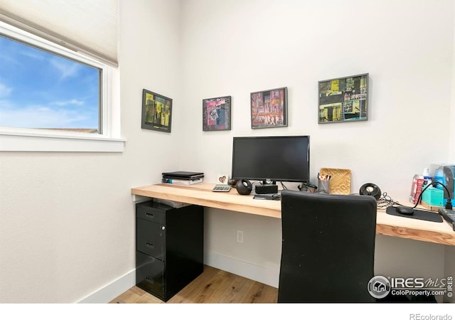 7061 Sage Meadows Dr, Wellington, CO 80549 - home office with wood finished floors and baseboards