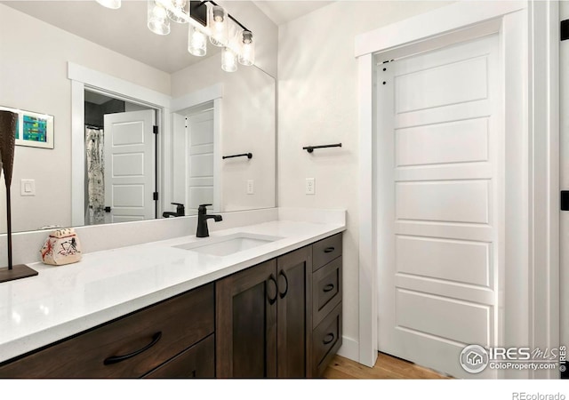 7061 Sage Meadows Dr, Wellington, CO 80549 - full bathroom featuring vanity and wood finished floors