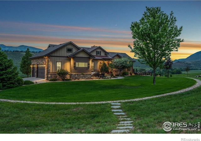 9738 Buckhorn Ridge Way, Loveland, CO 80538 - craftsman-style house featuring board and batten siding, a garage, a front lawn, stone siding, and a mountain view