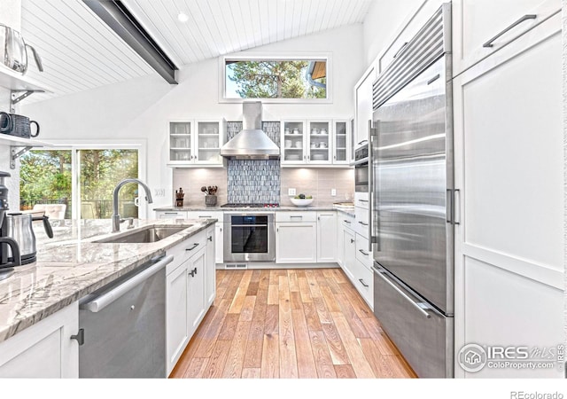 279 Green Meadow Ln, Boulder, CO 80302 - kitchen featuring appliances with stainless steel finishes, wall chimney range hood, light wood-style floors, a sink, and healthy amount of natural light