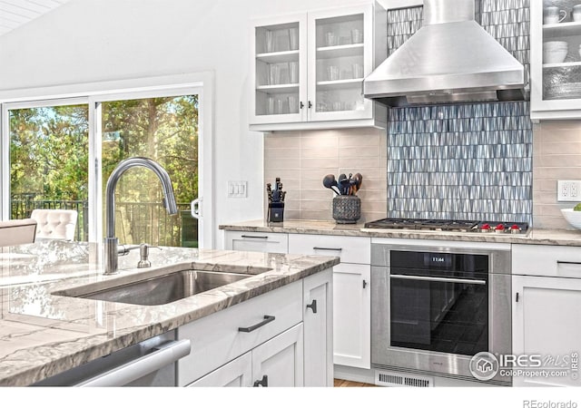 279 Green Meadow Ln, Boulder, CO 80302 - kitchen with appliances with stainless steel finishes, island exhaust hood, a sink, white cabinetry, and glass insert cabinets