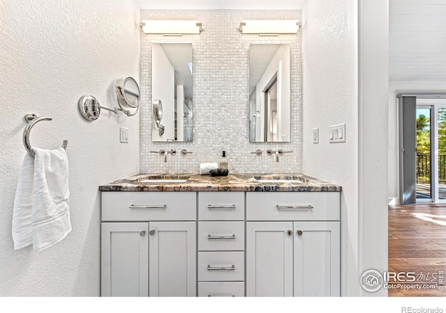 279 Green Meadow Ln, Boulder, CO 80302 - full bath featuring double vanity, backsplash, wood finished floors, and a textured wall