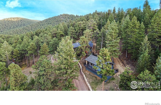 279 Green Meadow Ln, Boulder, CO 80302 - view of subject property featuring a heavily wooded area and a mountain backdrop