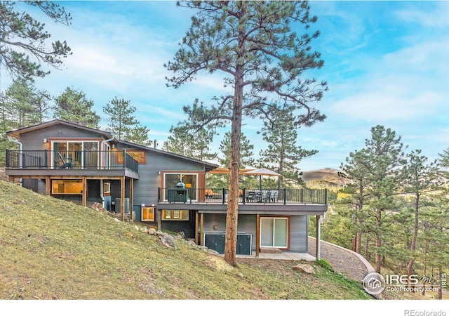 279 Green Meadow Ln, Boulder, CO 80302 - back of property with a wooden deck and a lawn