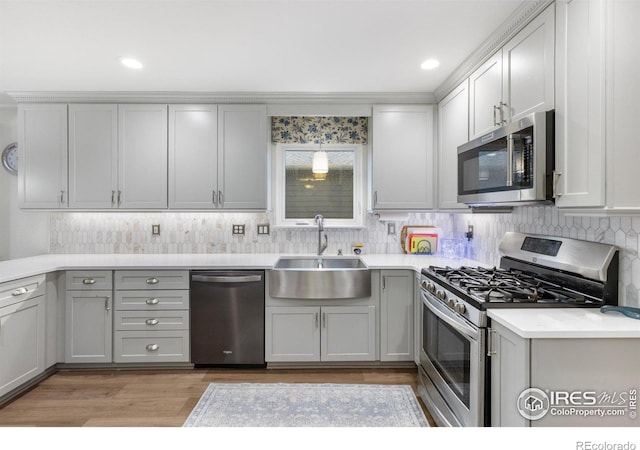 3023 39th Ave, Evans, CO 80620 - kitchen with stainless steel appliances, a sink, gray cabinets, backsplash, and recessed lighting